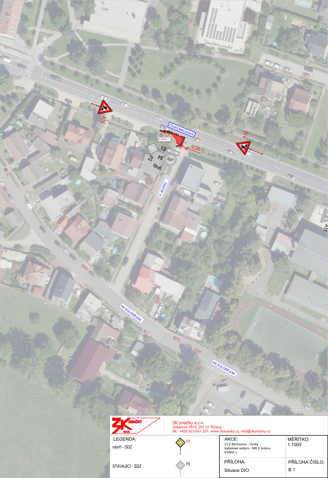 Situační nákres DIO (dopravně inženýrského opatření) pro akci 'I/12 Běchovice - Úvaly, kabelové vedení - MK K Jelenu, ETAPA 1'. Mapa zobrazuje úsek silnice ČESKOBRODSKÁ a přilehlou ulici K JELENU. Vyznačena je pracovní oblast (červené šrafování) o šířce 3,25 m a umístění dopravního značení A15 (práce na silnici). V dolní části je legenda: návrh SDZ (svislého dopravního značení) - značka P2 (Hlavní pozemní komunikace), stávající SDZ - značka P2. Informace o zhotoviteli: 3K značky s.r.o., Jiráskova 1519, 251 01 Říčany, tel.: +420 323 601 237, www.3kznacky.cz, info@3kznacky.cz. Měřítko 1:1000, příloha B.1.
