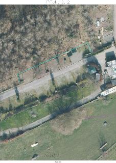 Ortofotomapa s vyznačenými hranicemi parcel a zvýrazněnou oblastí (modrá linka) v katastrálním území. Čitelné popisky parcel: 1605, 1606/1, 1607, 1608, 1609, 1…