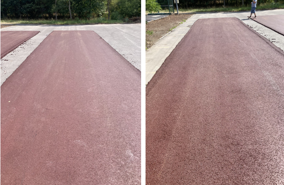 Fotografie nově položeného červeného asfaltového povrchu na pozemku.
