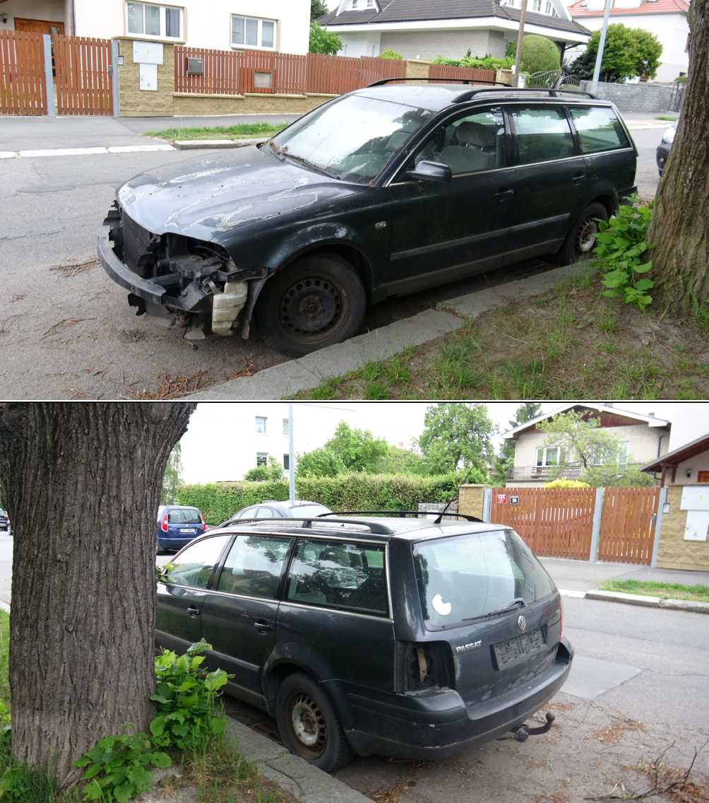 Fotografie poškozeného osobního automobilu značky Volkswagen Passat (kombi), který je odstaven u stromu na ulici. Na zadní části vozu je čitelný nápis 'PASSAT'.