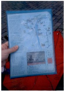 Turistická mapa a leták o Praze v modrém obalu. Obsahuje text: '1. Máj as International Workers' Day...', 'How Czechs Celebrate Today...', 'Conclusion: For Cze…
