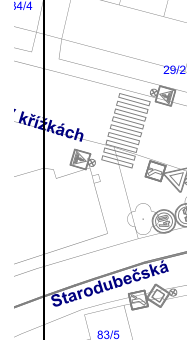 Výřez situačního plánu nebo mapy s vyznačením dopravního značení (přechod pro chodce, dopravní značky). V mapě jsou čitelné názvy ulic 'V křížkách' a 'Starodubečská', čísla parcel '34/4' a '83/5' a číslo popisné '29/2'.